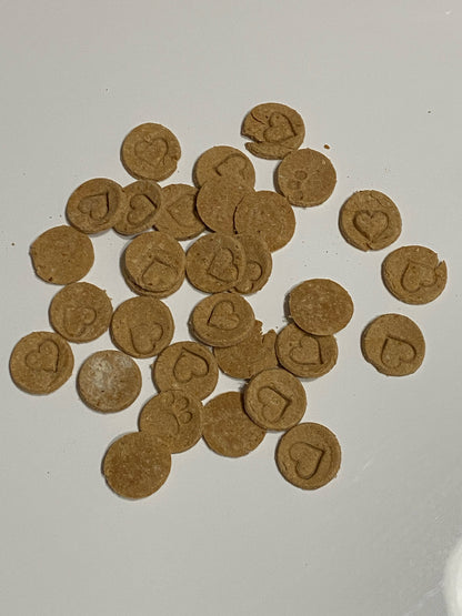 3/4 inch round dog treats, color brown stamped with hearts and paw prints